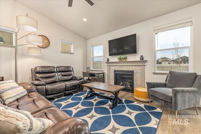 living room with wood finished floors, a fireplace, recessed lighting, ceiling fan, and vaulted ceiling