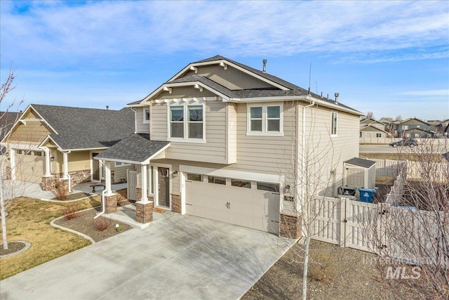 craftsman house with driveway, fence, a residential view, roof with shingles, and an attached garage