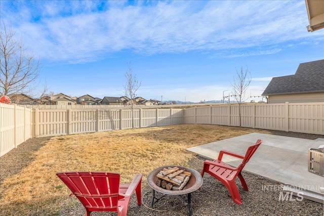 view of yard with a patio, a fenced backyard, and an outdoor fire pit