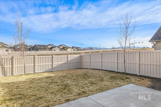 view of yard with a residential view and a fenced backyard