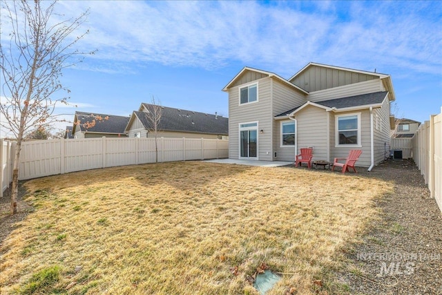 back of property with a patio, a fenced backyard, cooling unit, a yard, and board and batten siding