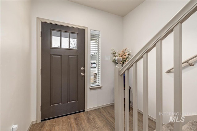 entryway featuring baseboards and wood finished floors