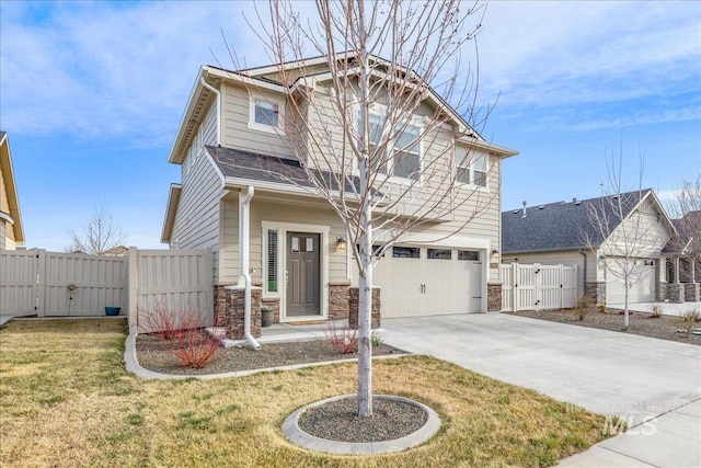 craftsman-style house with a gate, fence, stone siding, and driveway