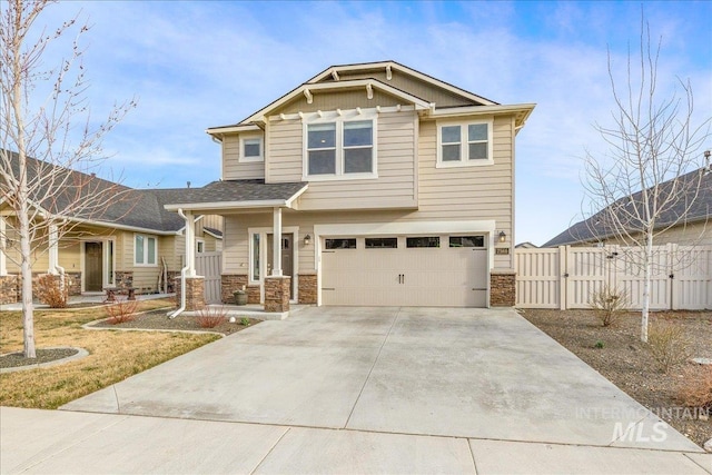 craftsman house featuring fence, concrete driveway, a garage, stone siding, and a gate