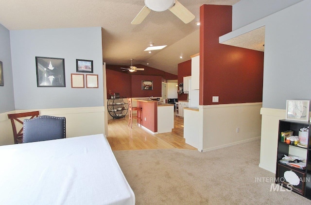 16696 Snowgoose St, Nampa, ID 83687 - kitchen with ceiling fan, vaulted ceiling, light colored carpet, a kitchen island, and open floor plan