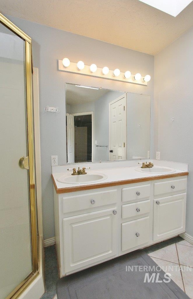 16696 Snowgoose St, Nampa, ID 83687 - bathroom featuring double vanity, a shower stall, and tile patterned flooring