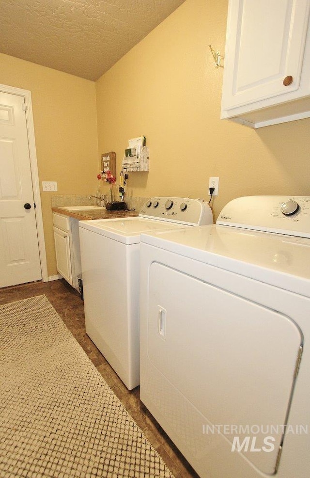 16696 Snowgoose St, Nampa, ID 83687 - laundry area with washing machine and clothes dryer, cabinet space, and a textured ceiling