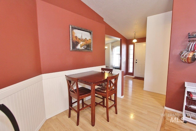 16696 Snowgoose St, Nampa, ID 83687 - dining room featuring vaulted ceiling, light wood-style flooring, and wainscoting
