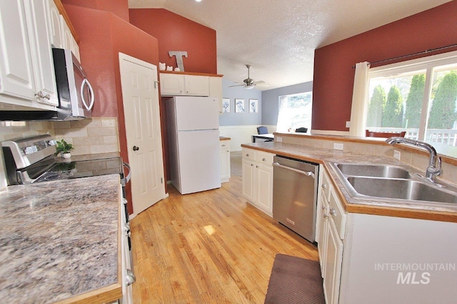 16696 Snowgoose St, Nampa, ID 83687 - kitchen featuring appliances with stainless steel finishes, white cabinetry, ceiling fan, lofted ceiling, and a textured ceiling