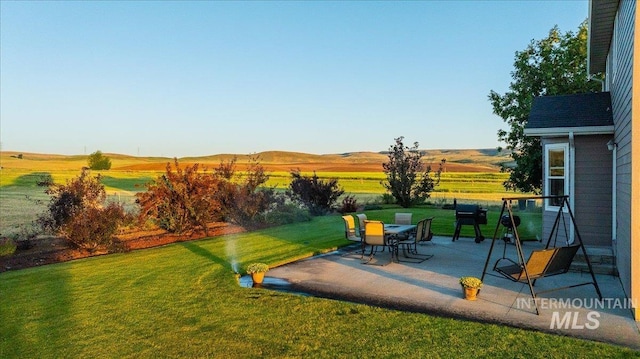 2020 Widner Rd, Midvale, ID 83645 - view of green lawn featuring a patio area and a mountain view