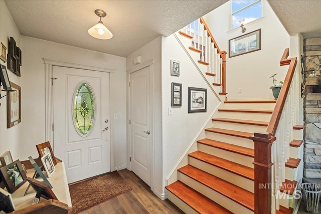 2020 Widner Rd, Midvale, ID 83645 - entrance foyer featuring stairway, wood finished floors, a textured ceiling, and healthy amount of natural light