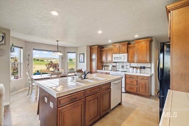 2020 Widner Rd, Midvale, ID 83645 - kitchen featuring white appliances, brown cabinets, tasteful backsplash, a textured ceiling, and recessed lighting