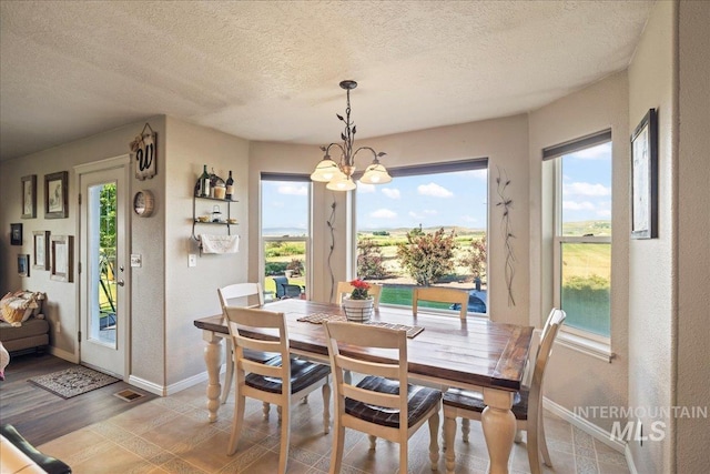 2020 Widner Rd, Midvale, ID 83645 - dining space with a chandelier, a textured ceiling, and healthy amount of natural light
