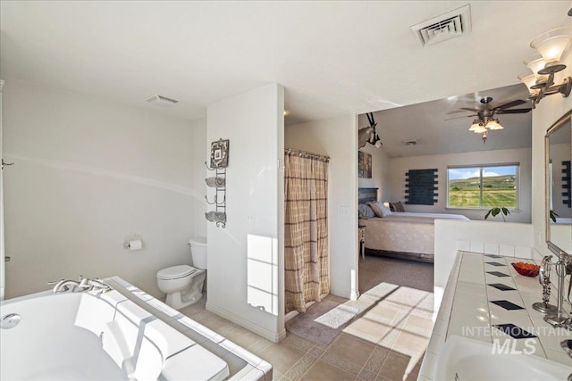 2020 Widner Rd, Midvale, ID 83645 - full bathroom featuring a ceiling fan, a fireplace, connected bathroom, a tub to relax in, and a shower with curtain