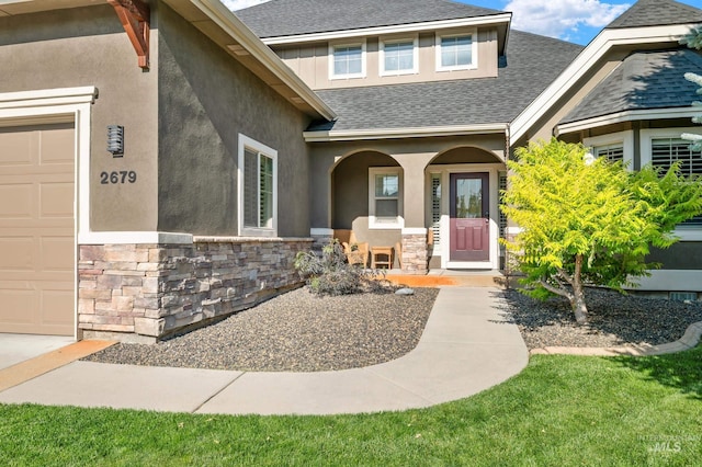2679 S Tristram Way, Meridian, ID 83642 - view of exterior entry featuring stone siding, roof with shingles, covered porch, and stucco siding
