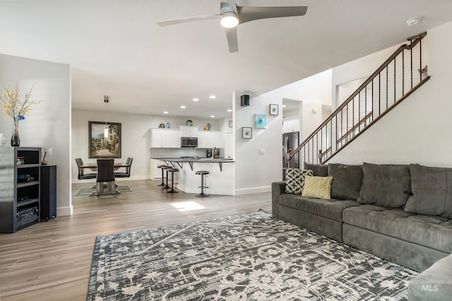 2679 S Tristram Way, Meridian, ID 83642 - living room with light wood-style flooring, ceiling fan, baseboards, stairway, and recessed lighting