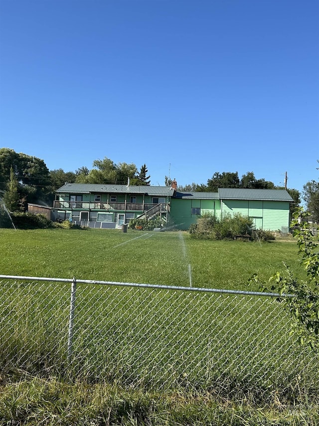 view of front of house with a front yard and fence