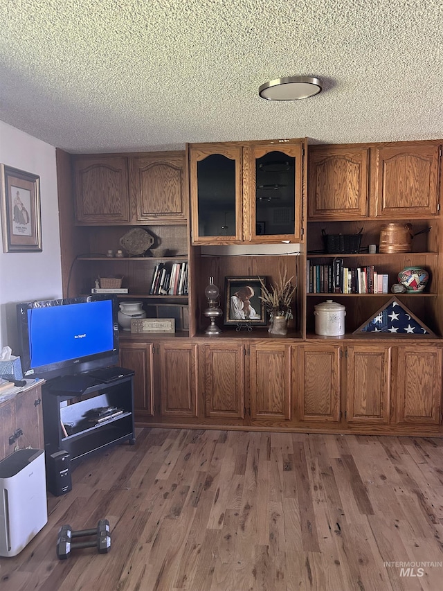 office with hardwood / wood-style floors and a textured ceiling