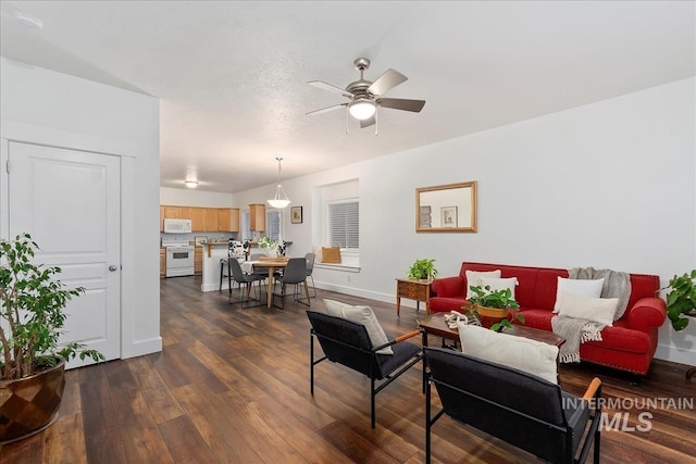 living room featuring dark hardwood / wood-style floors and ceiling fan