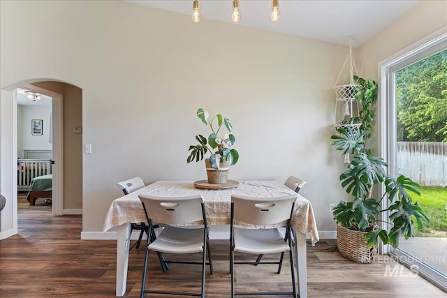3318 E Princess Amy Ct, Nampa, ID 83687 - dining area with arched walkways, wood finished floors, and baseboards