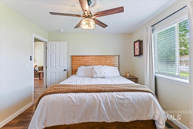 3318 E Princess Amy Ct, Nampa, ID 83687 - bedroom with baseboards, dark wood-style flooring, multiple windows, a textured ceiling, and ceiling fan