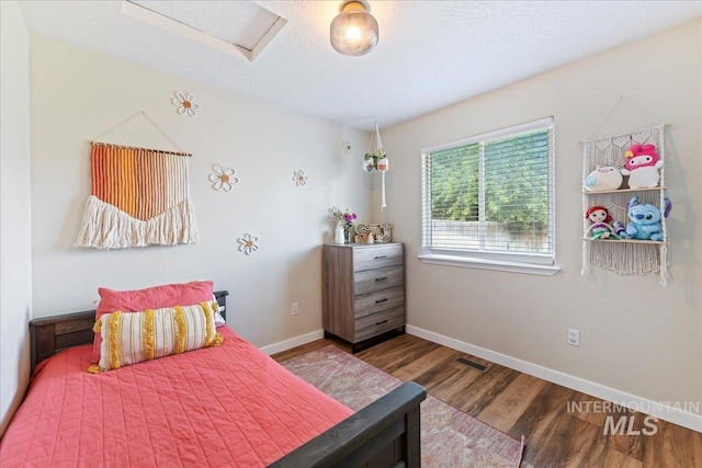 3318 E Princess Amy Ct, Nampa, ID 83687 - bedroom featuring wood finished floors, attic access, baseboards, and a textured ceiling