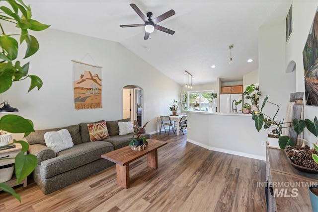 3318 E Princess Amy Ct, Nampa, ID 83687 - living room featuring arched walkways, light wood-type flooring, a ceiling fan, vaulted ceiling, and recessed lighting