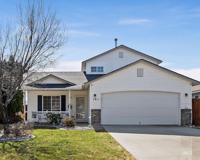 traditional-style house featuring fence, driveway, covered porch, a front lawn, and a garage