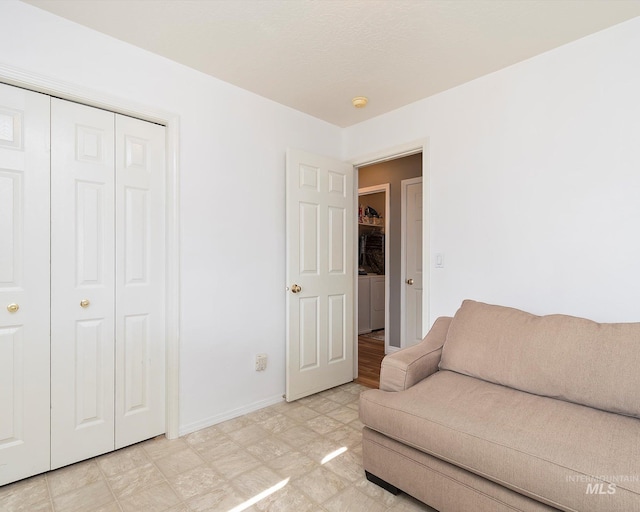 living area featuring light floors and baseboards