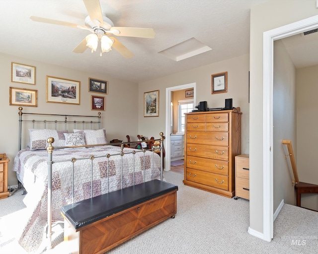 bedroom with visible vents, a textured ceiling, carpet, baseboards, and ceiling fan