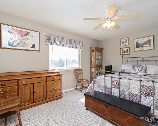 bedroom with baseboards, light carpet, and a ceiling fan