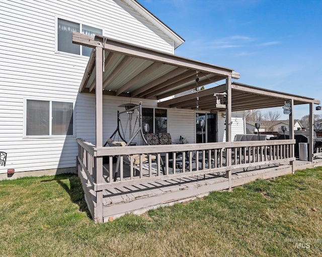 deck with a carport and a lawn