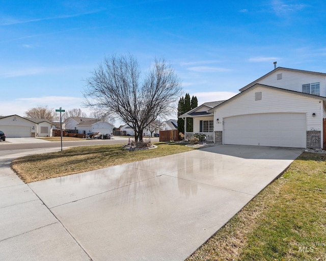 exterior space with an attached garage, a yard, and driveway