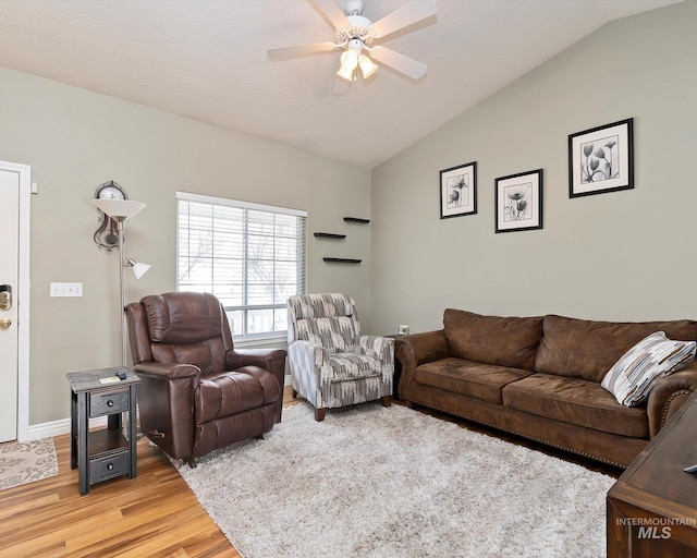 living room with light wood-style flooring, lofted ceiling, and ceiling fan