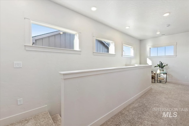 corridor with light colored carpet