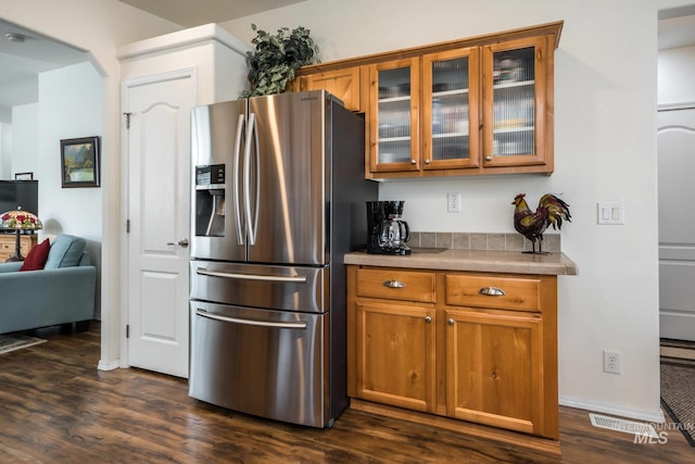 421 Curtis Rd Unit 120, Boise, ID 83705 - kitchen featuring stainless steel fridge with ice dispenser, brown cabinetry, glass insert cabinets, dark wood-style flooring, and light countertops