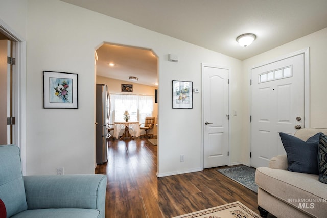 421 Curtis Rd Unit 120, Boise, ID 83705 - foyer with dark wood-style floors, arched walkways, baseboards, and lofted ceiling