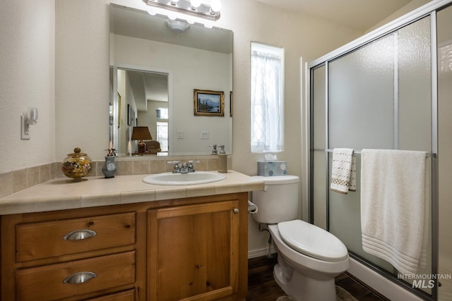 421 Curtis Rd Unit 120, Boise, ID 83705 - bathroom featuring a shower stall, vanity, toilet, and wood finished floors