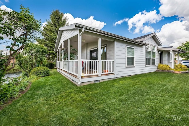 421 Curtis Rd Unit 120, Boise, ID 83705 - rear view of house with covered porch and a lawn