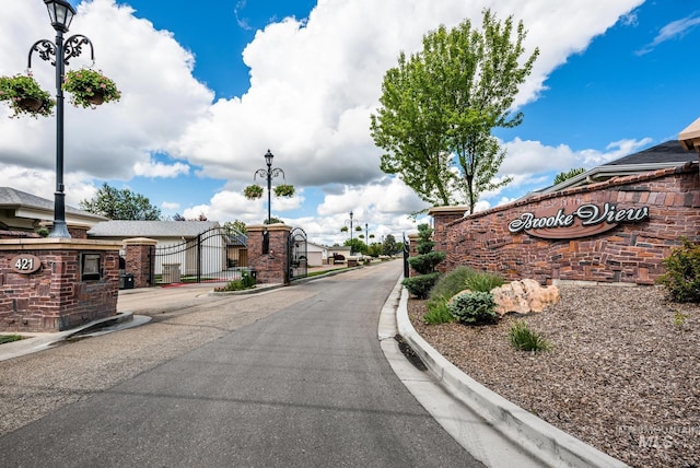 421 Curtis Rd Unit 120, Boise, ID 83705 - view of asphalt street with a gate, curbs, a gated entry, and street lighting