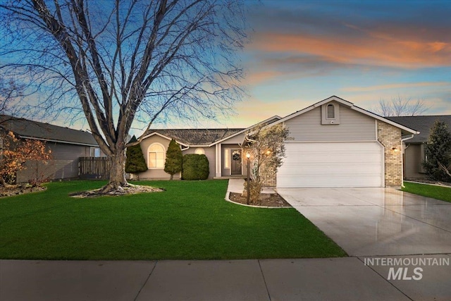 ranch-style house featuring a lawn and a garage