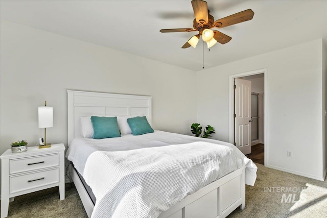 bedroom featuring ceiling fan and dark carpet