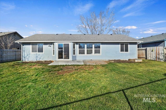 back of property featuring a patio and a yard