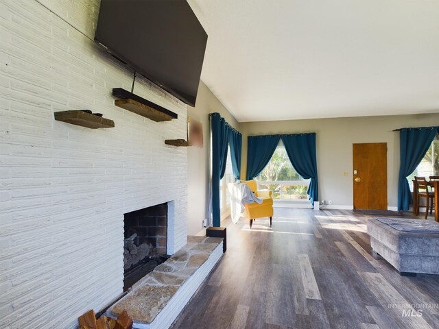 unfurnished living room featuring a large fireplace and hardwood / wood-style floors