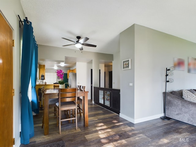 dining room with a textured ceiling, dark hardwood / wood-style floors, and ceiling fan