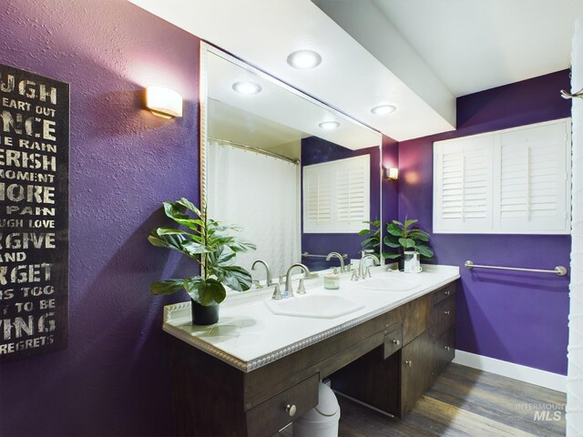 bathroom featuring double sink vanity and hardwood / wood-style flooring