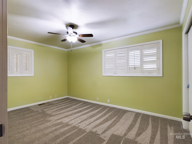 carpeted spare room featuring crown molding and ceiling fan