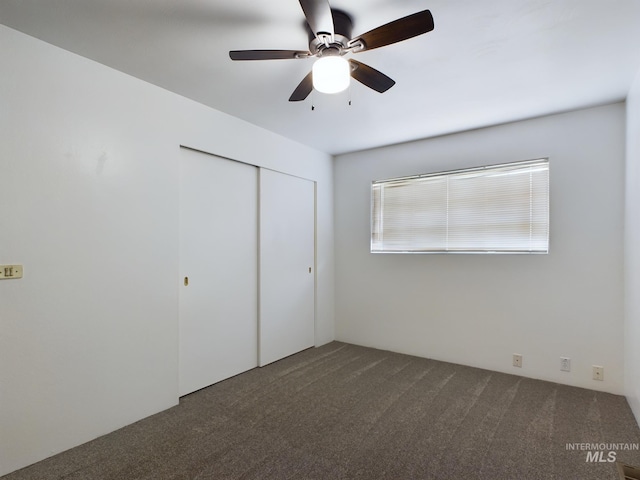 unfurnished bedroom featuring carpet, a closet, and ceiling fan