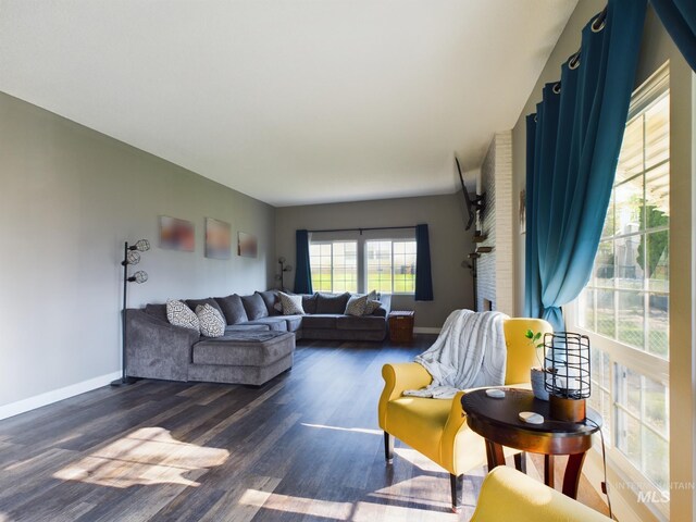 living room featuring brick wall and dark hardwood / wood-style floors