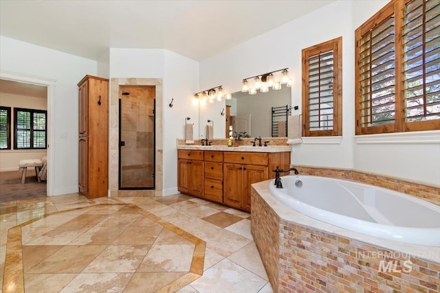 1512 E Rivers End Ct, Eagle, ID 83616 - bathroom with a garden tub, double vanity, a shower stall, inlaid floor details, and tile patterned flooring